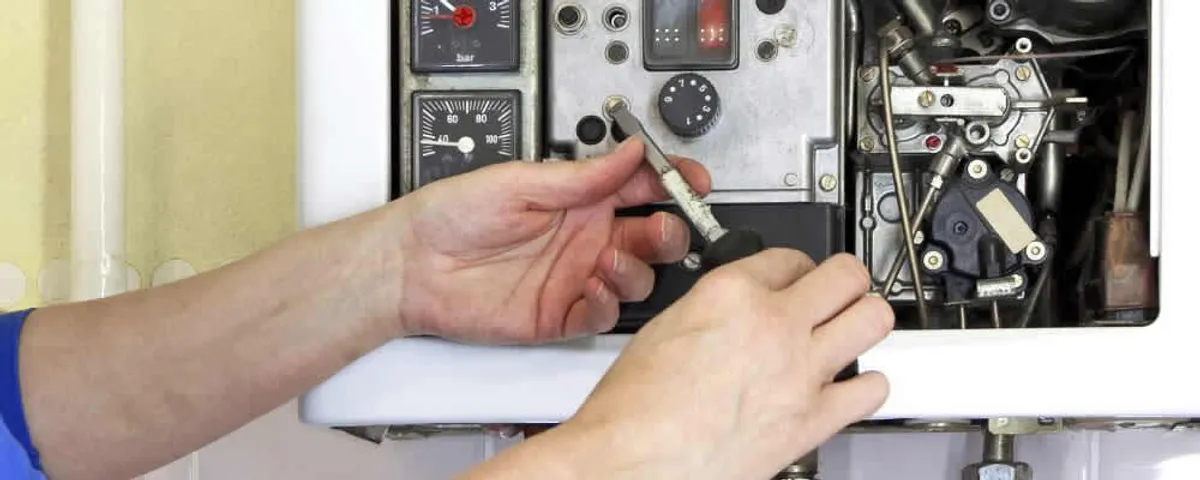 Heating repair technician adjusting boiler controls and components in Harrisburg, PA