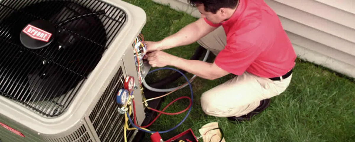 HVAC technician servicing an outdoor air conditioner unit in Harrisburg, PA
