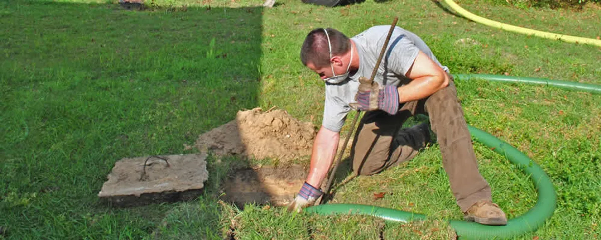 Septic pumping technician servicing a residential septic tank in Harrisburg, PA